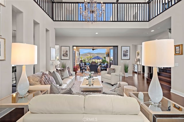 7051 Sitio Caliente, Carlsbad, CA 92009 - living area with a high ceiling, wood finished floors, a chandelier, and baseboards