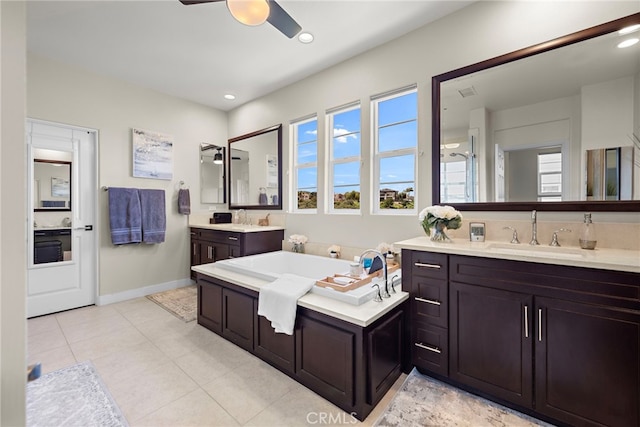 7051 Sitio Caliente, Carlsbad, CA 92009 - bathroom with ceiling fan, healthy amount of natural light, a garden tub, two vanities, and recessed lighting
