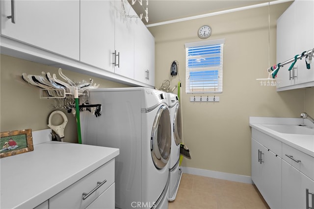 7051 Sitio Caliente, Carlsbad, CA 92009 - laundry area featuring washing machine and clothes dryer, cabinet space, baseboards, light tile patterned floors, and crown molding