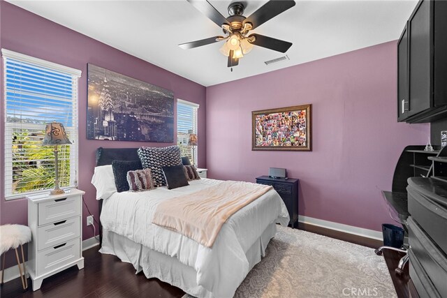 7051 Sitio Caliente, Carlsbad, CA 92009 - bedroom featuring baseboards, multiple windows, a ceiling fan, and dark wood-style floors