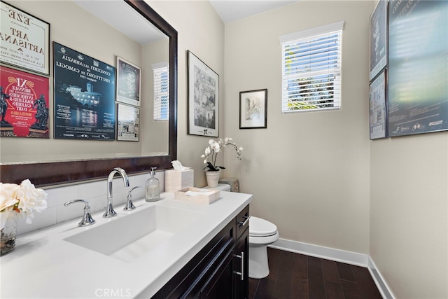 7051 Sitio Caliente, Carlsbad, CA 92009 - bathroom featuring baseboards, wood finished floors, toilet, and vanity