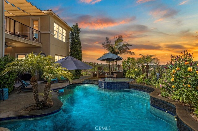 7051 Sitio Caliente, Carlsbad, CA 92009 - pool at dusk featuring a patio area and a pool with connected hot tub