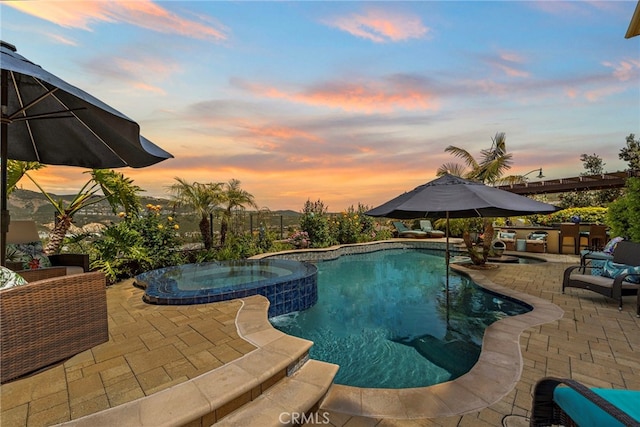 7051 Sitio Caliente, Carlsbad, CA 92009 - pool at dusk featuring a patio and a pool with connected hot tub
