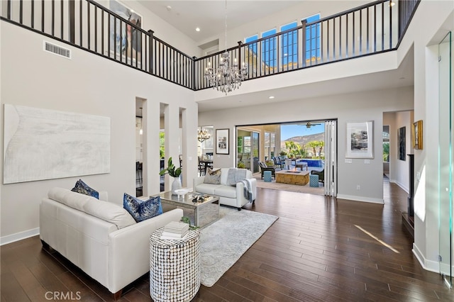 7051 Sitio Caliente, Carlsbad, CA 92009 - living area featuring a chandelier, hardwood / wood-style flooring, a towering ceiling, and recessed lighting