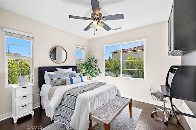 7051 Sitio Caliente, Carlsbad, CA 92009 - bedroom with multiple windows, a ceiling fan, and dark wood-type flooring