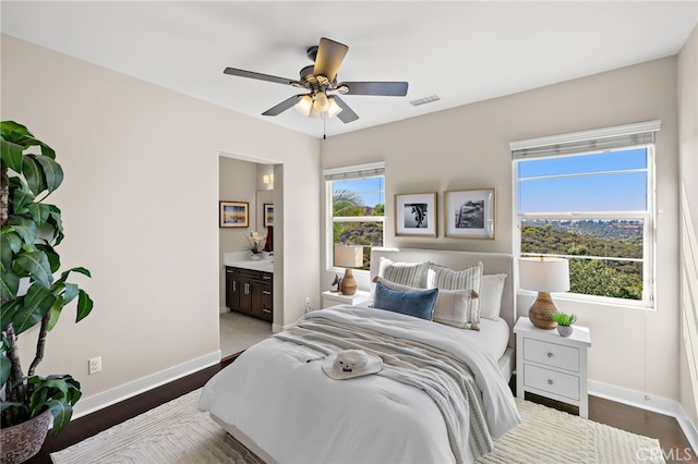7051 Sitio Caliente, Carlsbad, CA 92009 - bedroom featuring ensuite bathroom, wood finished floors, and a ceiling fan