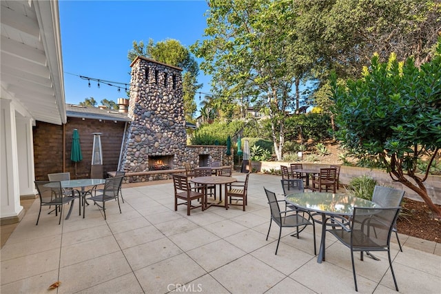 7051 Sitio Caliente, Carlsbad, CA 92009 - view of patio / terrace featuring an outdoor stone fireplace and outdoor dining area