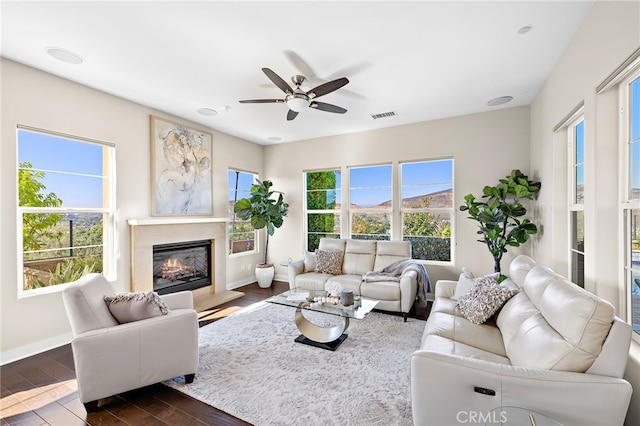 7051 Sitio Caliente, Carlsbad, CA 92009 - living area with ceiling fan, dark wood finished floors, and a glass covered fireplace