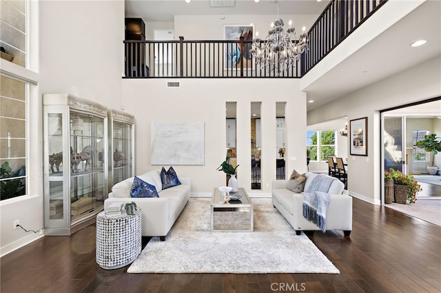 7051 Sitio Caliente, Carlsbad, CA 92009 - living area with hardwood / wood-style floors, a towering ceiling, and a chandelier