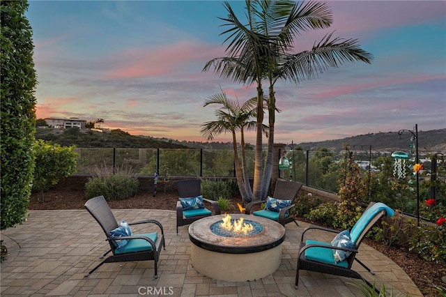 7051 Sitio Caliente, Carlsbad, CA 92009 - patio terrace at dusk featuring a patio and an outdoor fire pit