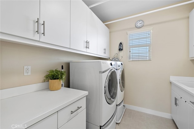 7051 Sitio Caliente, Carlsbad, CA 92009 - washroom featuring washing machine and clothes dryer, cabinet space, and light tile patterned floors