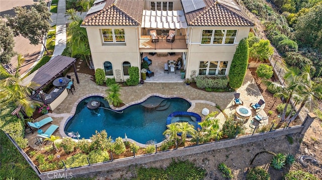 7051 Sitio Caliente, Carlsbad, CA 92009 - back of house featuring a balcony, stucco siding, a patio, a tile roof, and a pool with connected hot tub