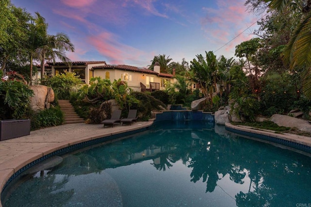 10845 Mystery Mountain Rd, Valley Center, CA 92082 - pool at dusk featuring stairs, an outdoor pool, a water slide, and a patio