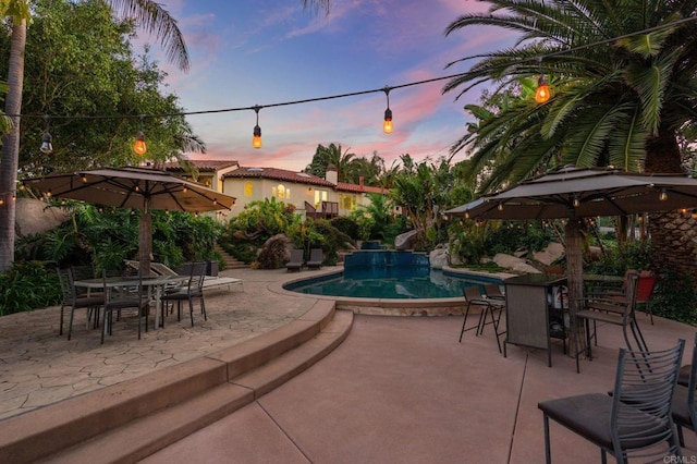 10845 Mystery Mountain Rd, Valley Center, CA 92082 - pool at dusk featuring outdoor dining space, an outdoor pool, and a patio area