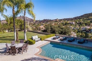 swimming pool featuring a patio area and a mountain view