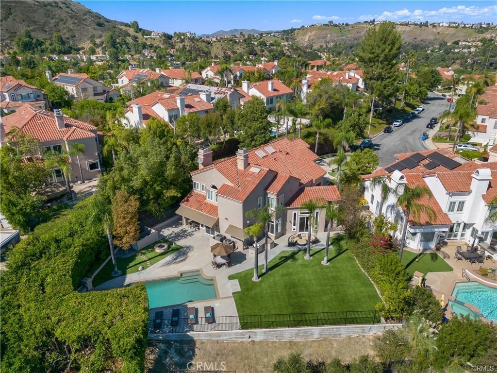 aerial view of property's location featuring nearby suburban area and a mountainous background