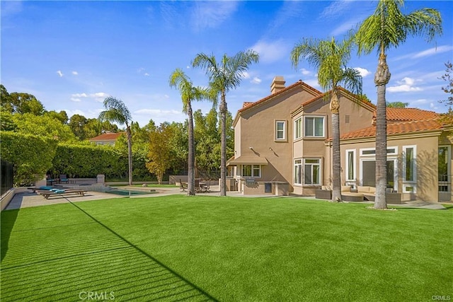 rear view of house featuring a patio, outdoor lounge area, stucco siding, and a swimming pool