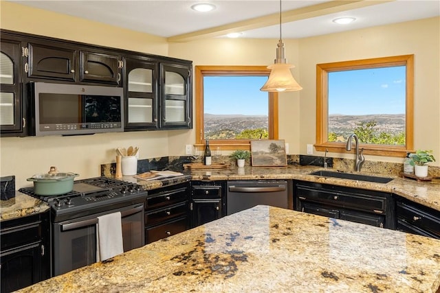 10885 San Marcos Rd, Atascadero, CA 93422 - kitchen with stainless steel appliances, a sink, light stone countertops, glass insert cabinets, and hanging light fixtures
