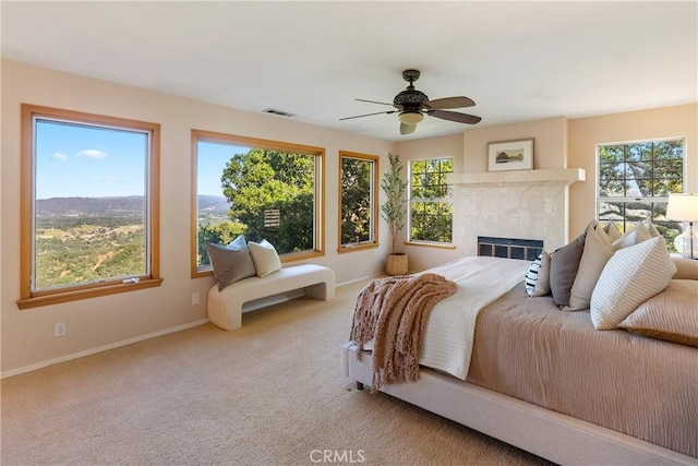 10885 San Marcos Rd, Atascadero, CA 93422 - bedroom with multiple windows, baseboards, carpet flooring, and a tile fireplace