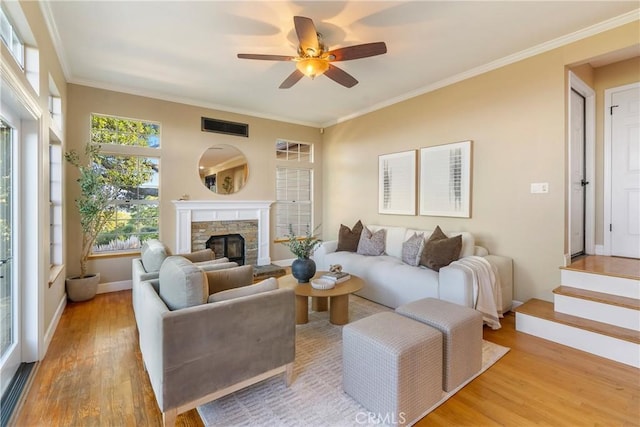 10885 San Marcos Rd, Atascadero, CA 93422 - living area with wood finished floors, baseboards, ceiling fan, ornamental molding, and a stone fireplace