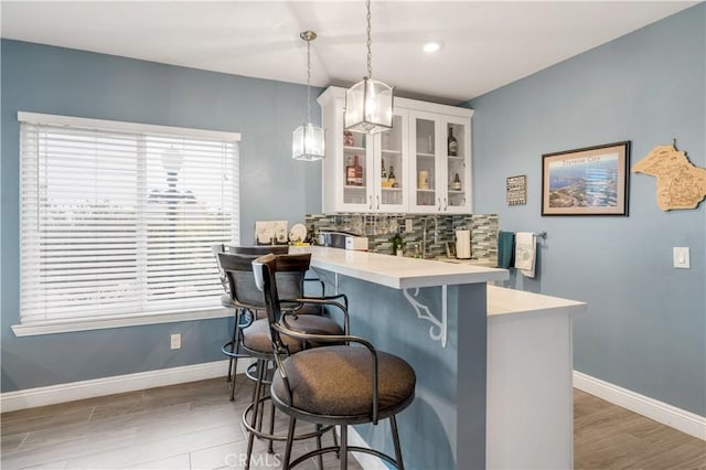 36755 Tierra Subida Ave, Palmdale, CA 93551 - bar area featuring backsplash, wood finished floors, baseboards, decorative light fixtures, and recessed lighting