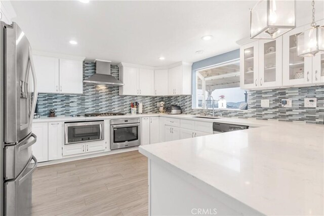 36755 Tierra Subida Ave, Palmdale, CA 93551 - kitchen featuring appliances with stainless steel finishes, wall chimney exhaust hood, a sink, decorative backsplash, and recessed lighting