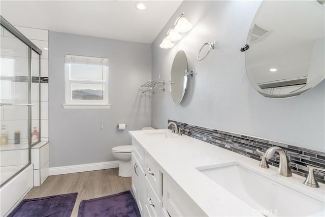 36755 Tierra Subida Ave, Palmdale, CA 93551 - full bath with tasteful backsplash, toilet, wood finished floors, baseboards, and combined bath / shower with glass door