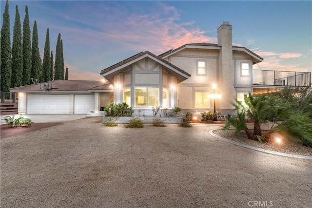 36755 Tierra Subida Ave, Palmdale, CA 93551 - view of front facade with stucco siding, driveway, a chimney, an attached garage, and a tile roof