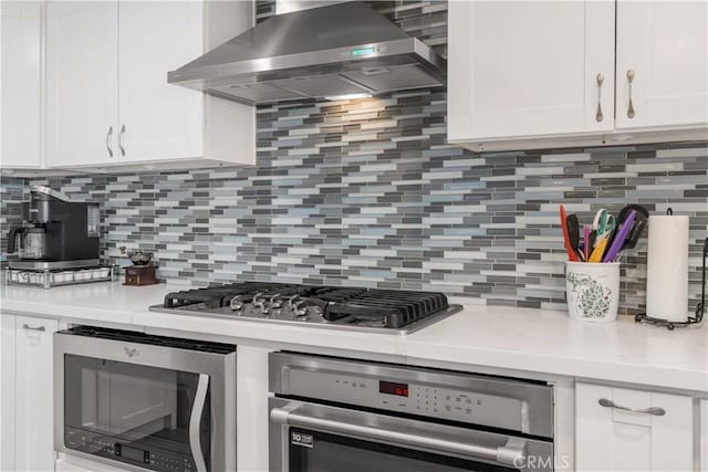 36755 Tierra Subida Ave, Palmdale, CA 93551 - kitchen featuring wall chimney range hood, appliances with stainless steel finishes, light countertops, and white cabinets