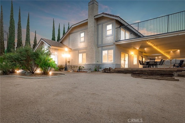 36755 Tierra Subida Ave, Palmdale, CA 93551 - rear view of property featuring a chimney, stucco siding, a balcony, a patio area, and outdoor dining area