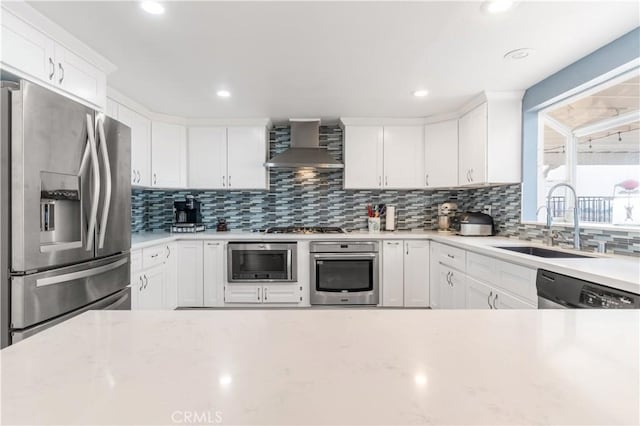 36755 Tierra Subida Ave, Palmdale, CA 93551 - kitchen with appliances with stainless steel finishes, wall chimney exhaust hood, a sink, tasteful backsplash, and recessed lighting
