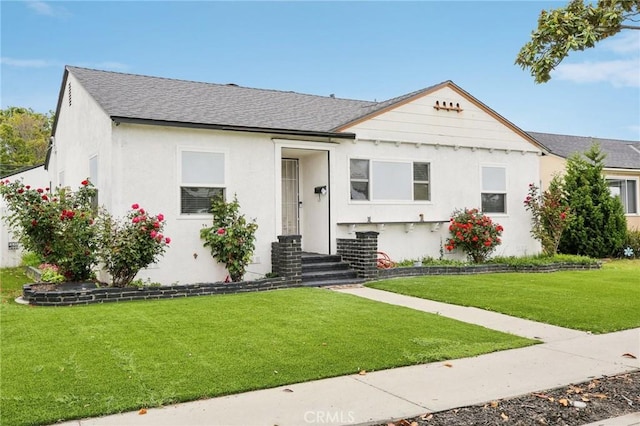 3686 Palo Verde Ave, Long Beach, CA 90808 - bungalow featuring stucco siding, roof with shingles, and a front yard