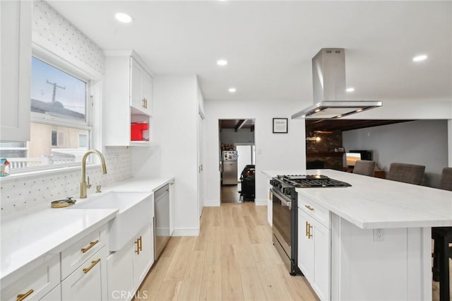 3686 Palo Verde Ave, Long Beach, CA 90808 - kitchen with range with gas stovetop, island exhaust hood, dishwasher, a sink, and a kitchen breakfast bar