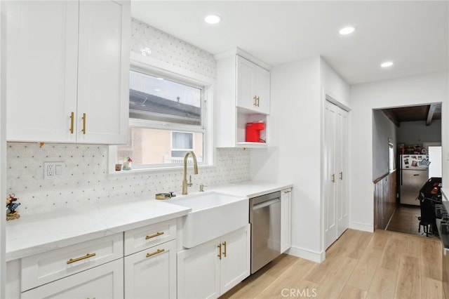 3686 Palo Verde Ave, Long Beach, CA 90808 - kitchen featuring stainless steel dishwasher, a sink, light wood finished floors, white cabinetry, and freestanding refrigerator