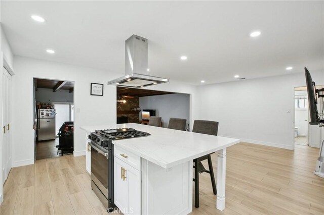 3686 Palo Verde Ave, Long Beach, CA 90808 - kitchen with gas stove, island range hood, white cabinetry, a center island, and light wood-type flooring
