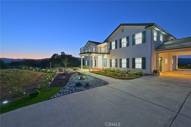 22252 Monte Rancho Dr, Temecula, CA 92590 - view of side of home with a balcony, driveway, and stucco siding