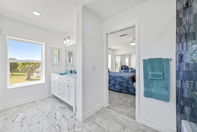 22252 Monte Rancho Dr, Temecula, CA 92590 - bathroom with vanity, baseboards, marble look tile flooring, ensuite bath, and a ceiling fan