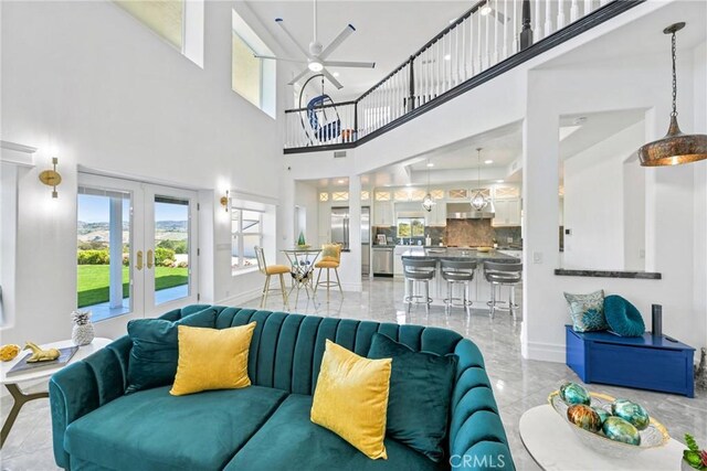 22252 Monte Rancho Dr, Temecula, CA 92590 - living room featuring french doors, healthy amount of natural light, light marble finish flooring, ceiling fan, and a high ceiling