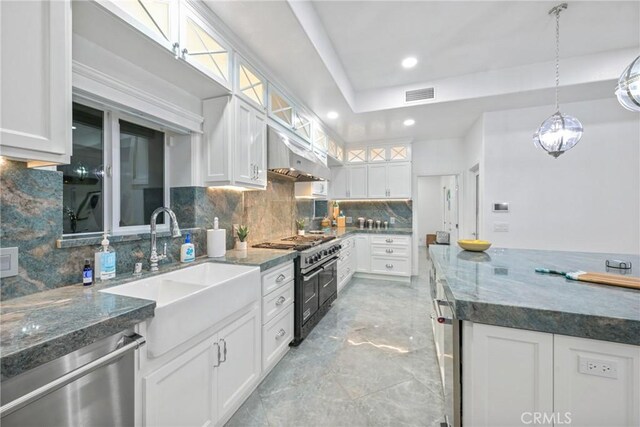 22252 Monte Rancho Dr, Temecula, CA 92590 - kitchen with stainless steel dishwasher, range with two ovens, a sink, decorative backsplash, and white cabinetry