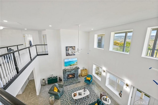 22252 Monte Rancho Dr, Temecula, CA 92590 - living area with a fireplace, recessed lighting, a ceiling fan, a high ceiling, and baseboards