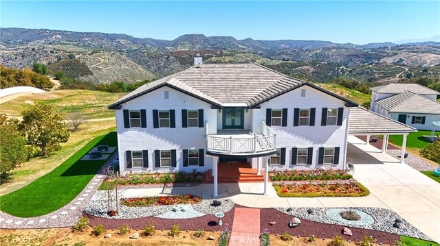 22252 Monte Rancho Dr, Temecula, CA 92590 - view of front of property with a balcony, a mountain view, concrete driveway, and an attached carport