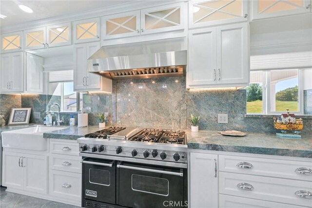 22252 Monte Rancho Dr, Temecula, CA 92590 - kitchen featuring double oven range, wall chimney range hood, a sink, and white cabinetry