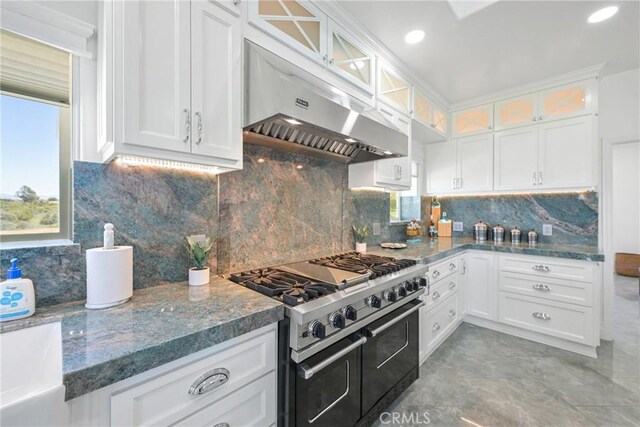 22252 Monte Rancho Dr, Temecula, CA 92590 - kitchen with range with two ovens, under cabinet range hood, healthy amount of natural light, white cabinetry, and recessed lighting