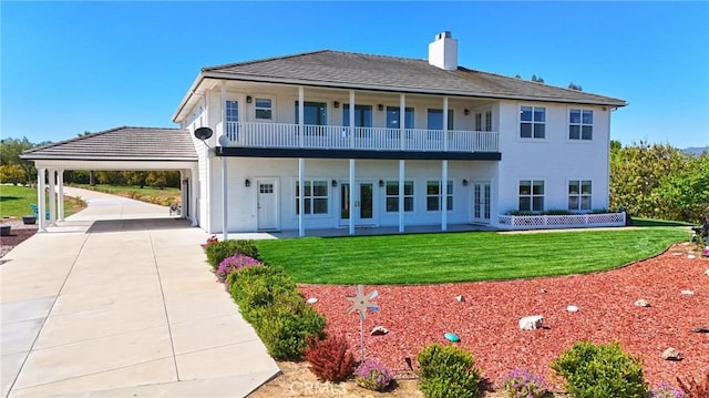 22252 Monte Rancho Dr, Temecula, CA 92590 - rear view of property with a balcony, a carport, a chimney, a lawn, and concrete driveway