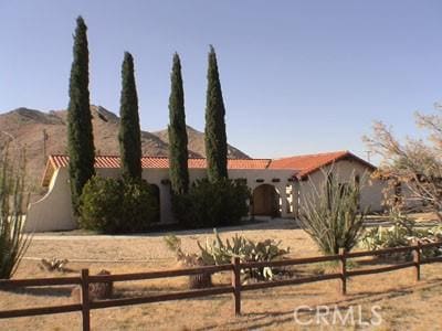 view of front of home featuring a tiled roof, a mountain view, and stucco siding