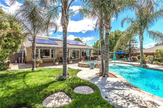 view of pool with a patio area and a pool with connected hot tub