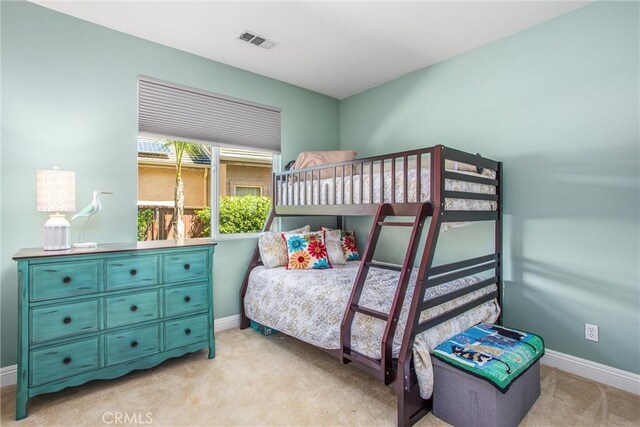 bedroom with light carpet and baseboards