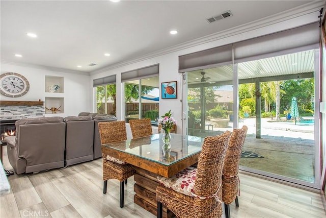 dining area featuring crown molding, light wood finished floors, recessed lighting, and ceiling fan