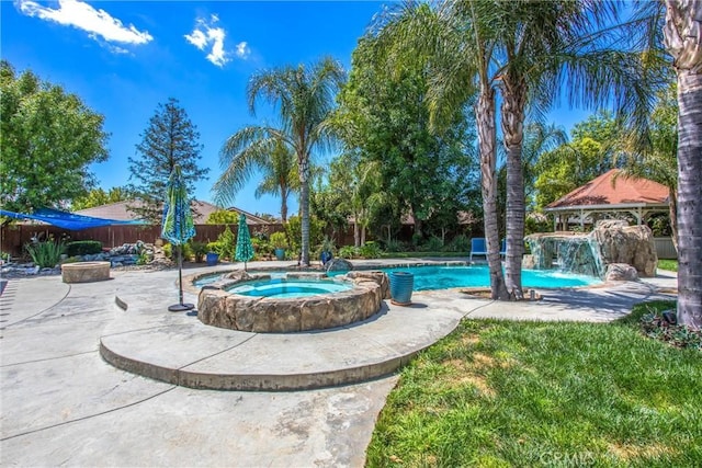 view of pool with a gazebo, a fenced backyard, a patio, and a pool with connected hot tub