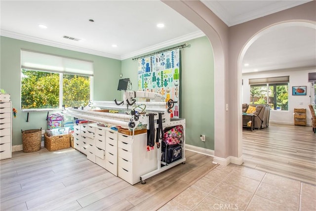 bedroom with wood finished floors, arched walkways, ornamental molding, recessed lighting, and baseboards